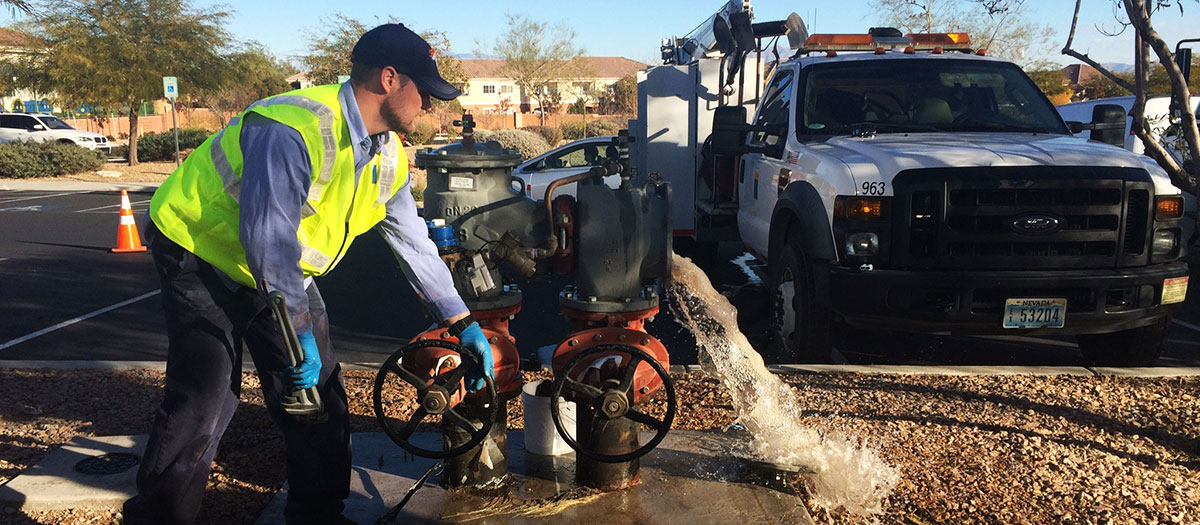 Las Vegas Valley Water District employee performing work on backflow prevention device.