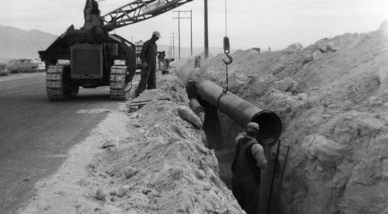 Grayscale photo of 16 inch cast iron pipeline placement at San Francisco Street in 1955 courtesy of UNLV Lied Library Special Collections Department.