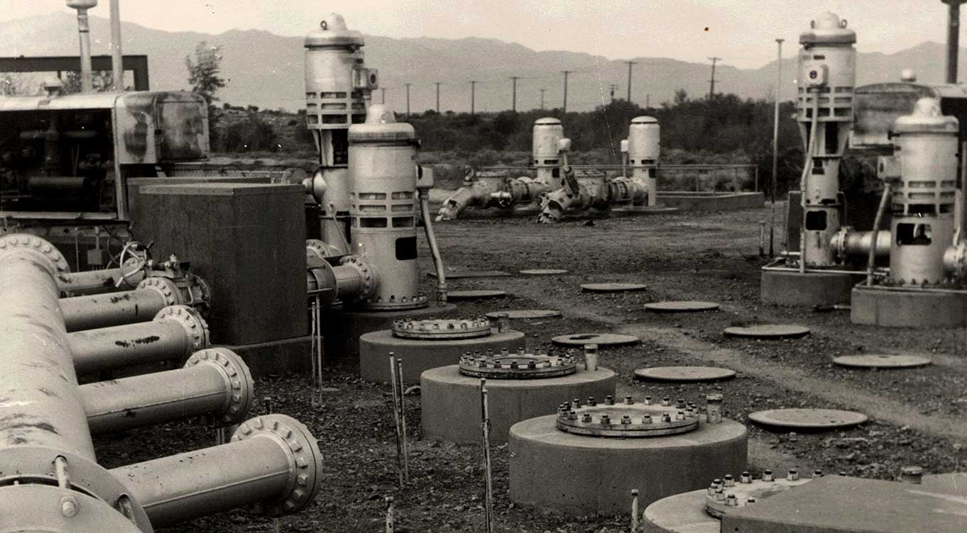 Grayscale photo of four water pumps.