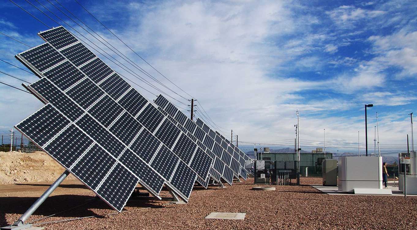 Group of solar panels at an angle on the ground installed at hydrogen fueling station.