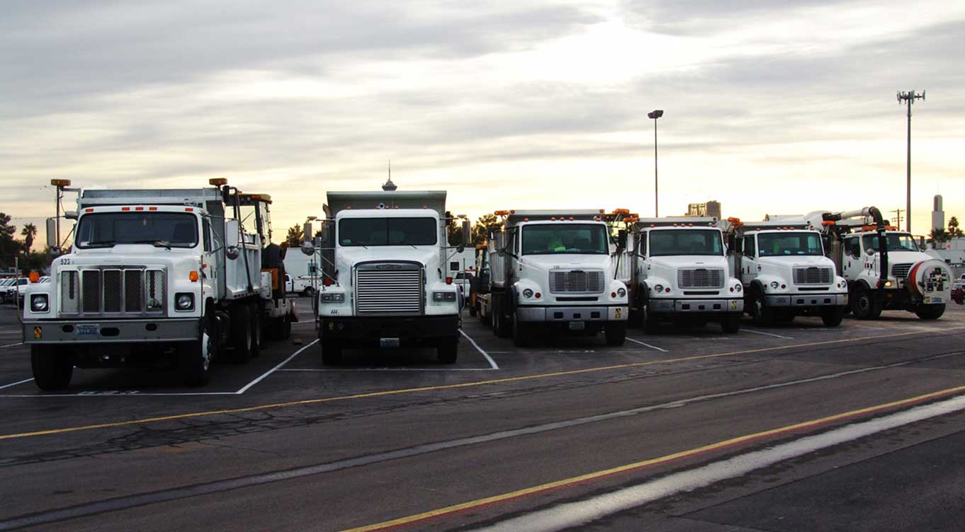 Front view of six LVVWD fleet trucks parked side-by-side.