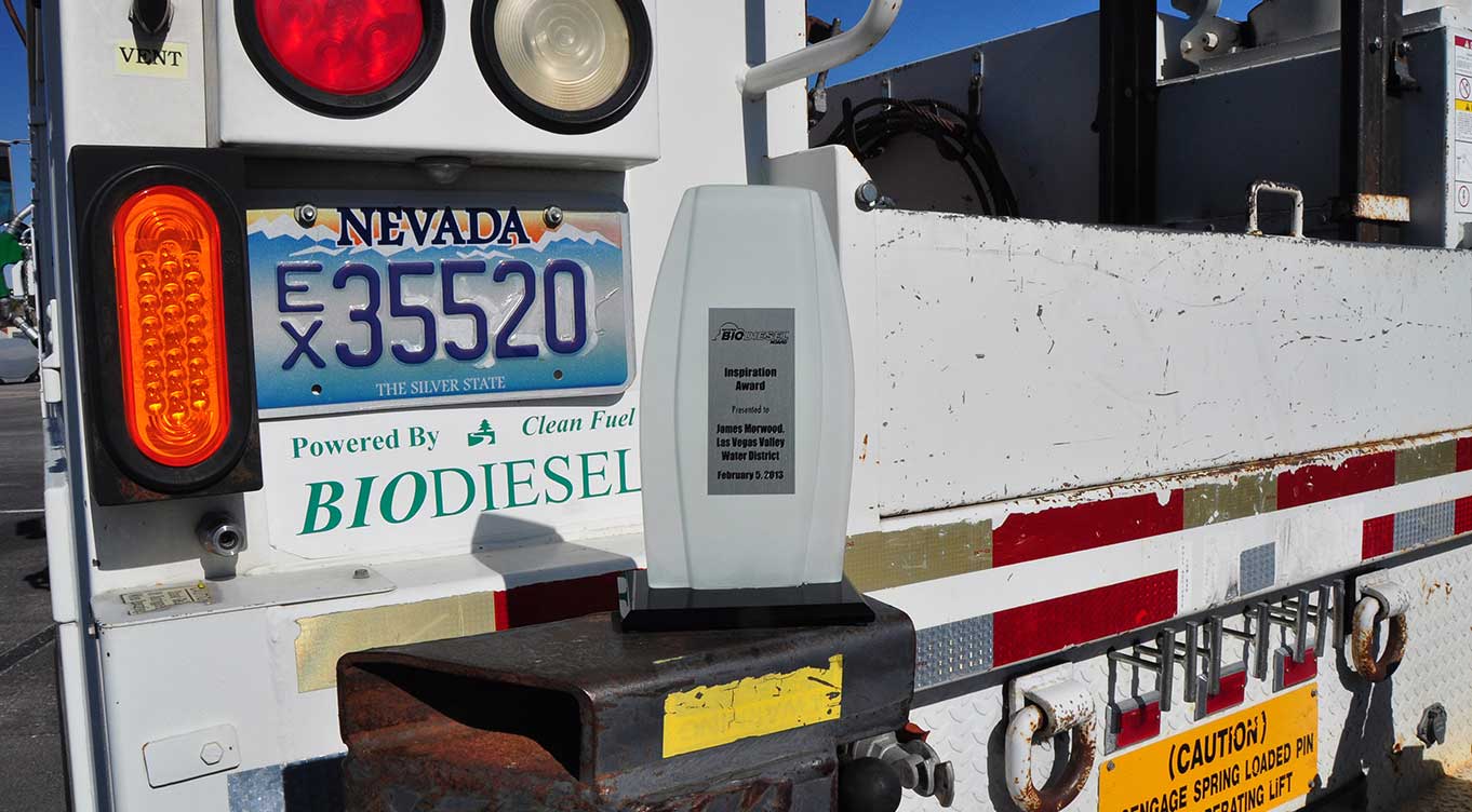 Rear of LVVWD fleet vehicle with Powered by Clean Fuel Biodiesel placard and award plaque placed on top of bumper.
