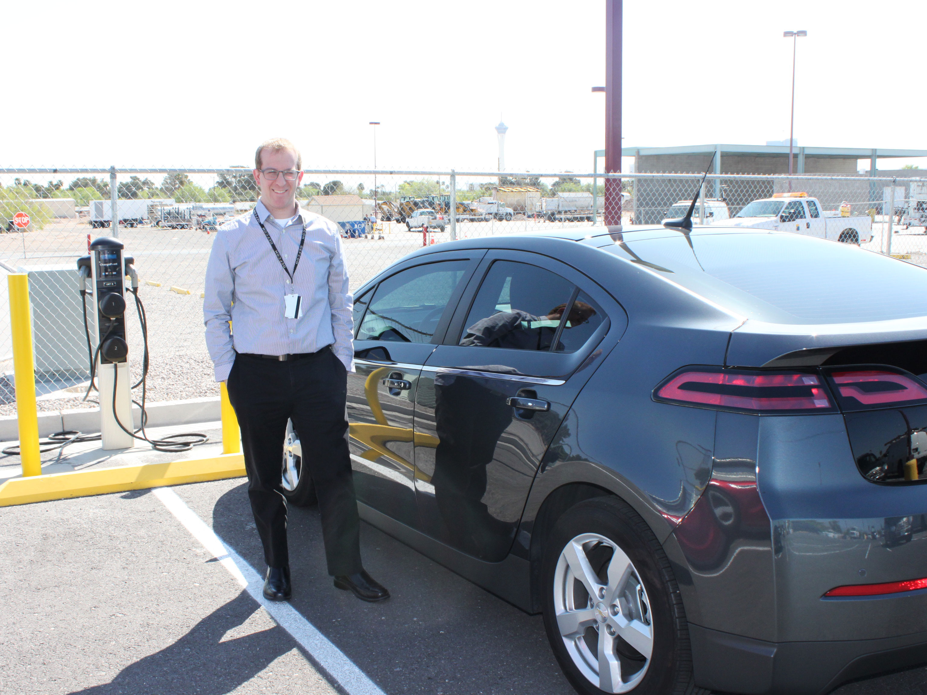 Staff member charging car.