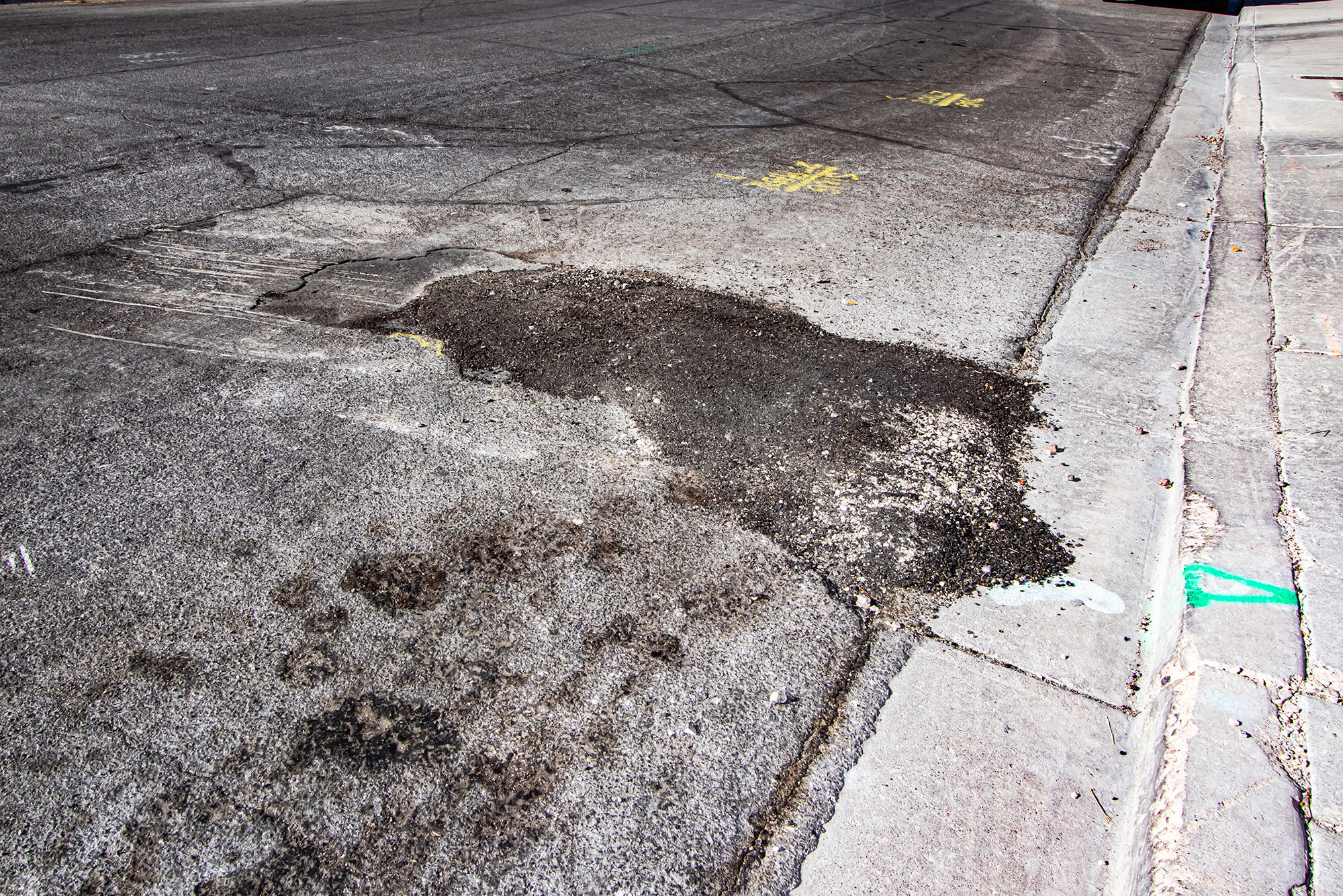 Temporary asphalt patch looks messy, unfinished