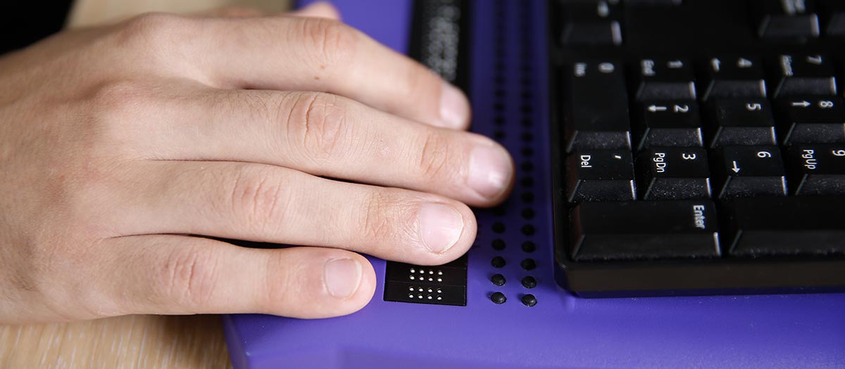 Hand on Braille keyboard