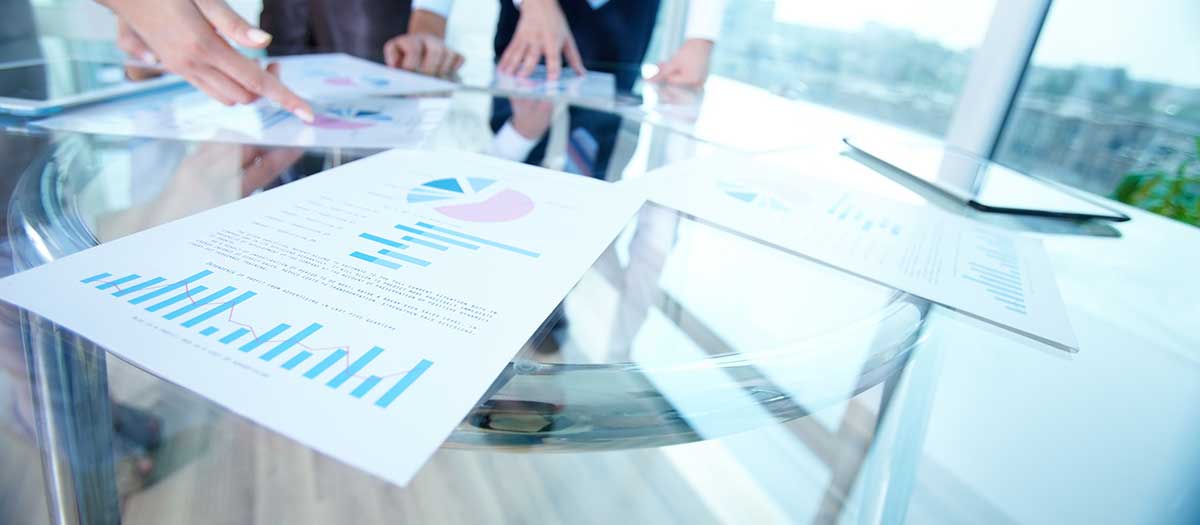 Financial reports with charts and graphs on table