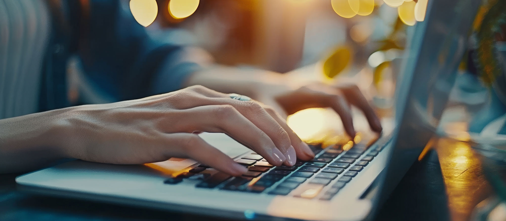 Woman's hands on laptop computer keyboard