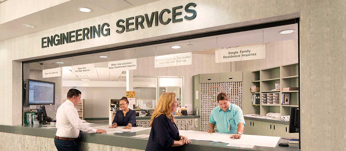 LVVWD employee assisting man at Engineering Services counter.