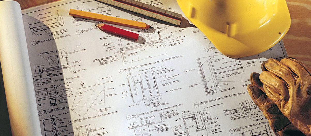 Plan document on table with hard hat