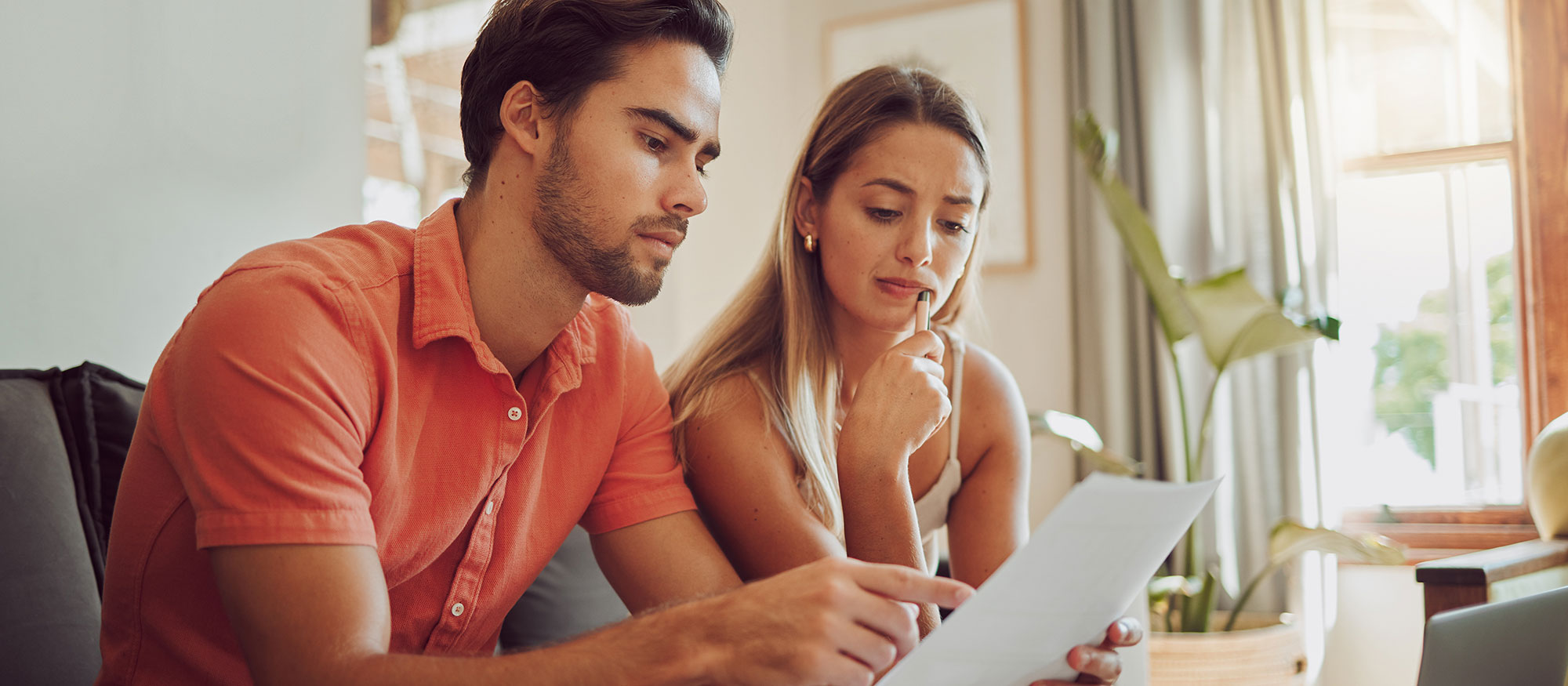 A man and woman look at their bill