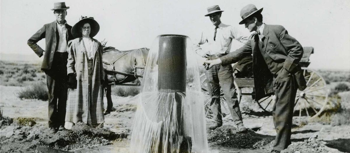 Ed Von Tobel and his wife posing with Jake and Will Beckley near an early water well.