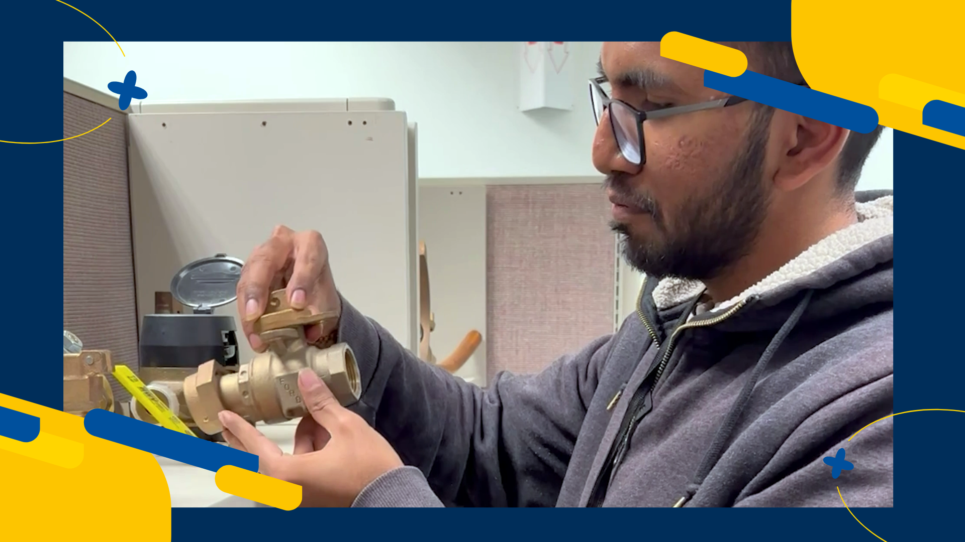 Intern inspecting brass valve.