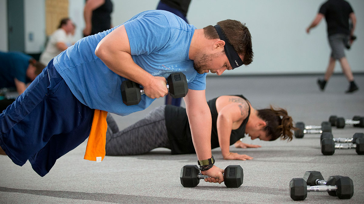 Man lifting weights in fitness class