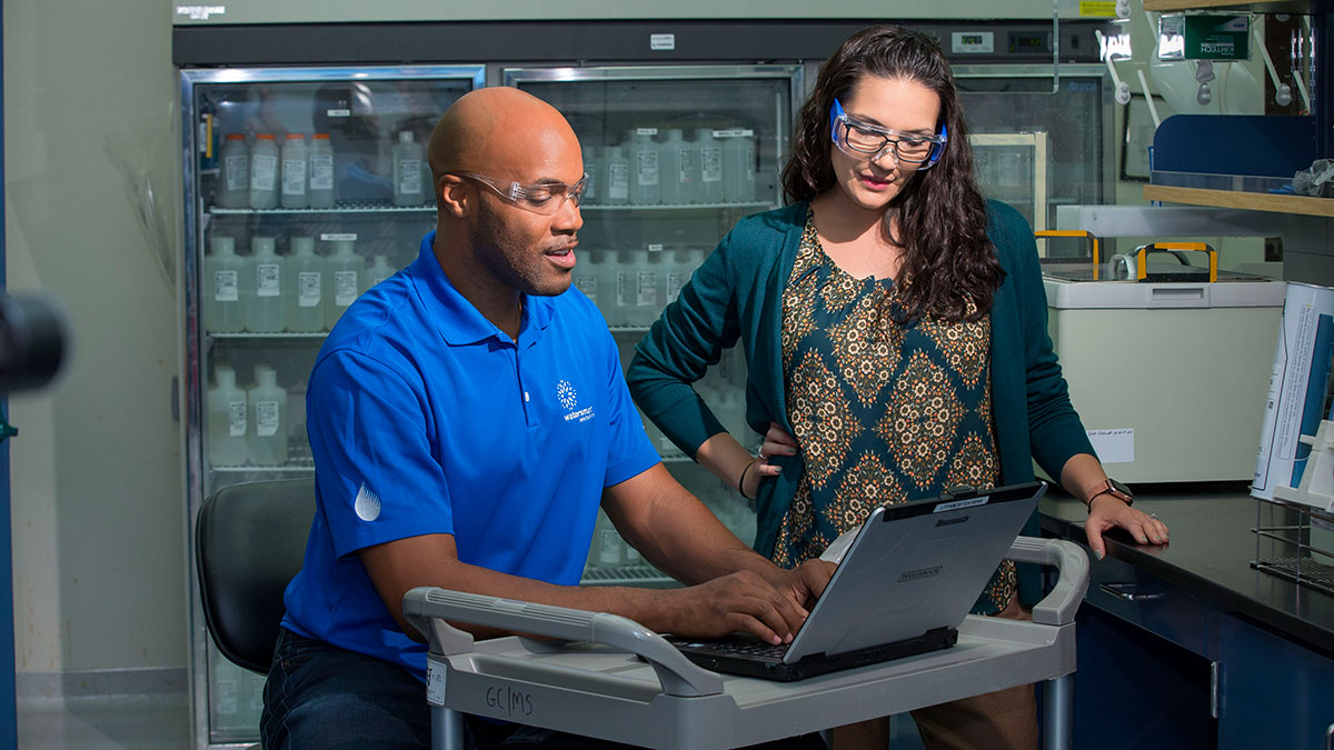 Man and woman working on computer in lab