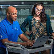 Man and woman working on computer in lab