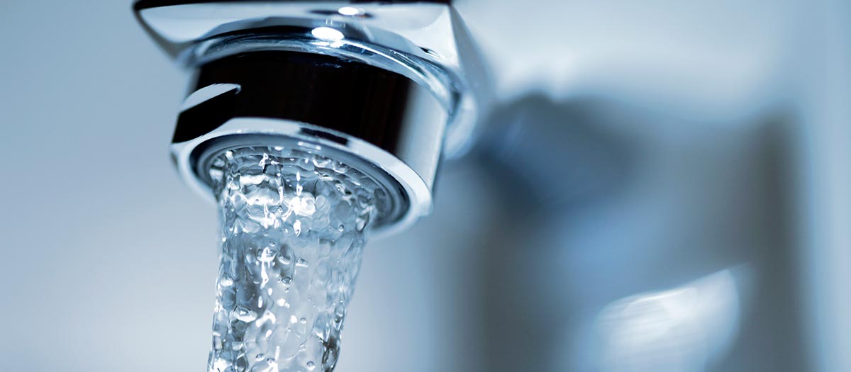 water flowing from a kitchen faucet